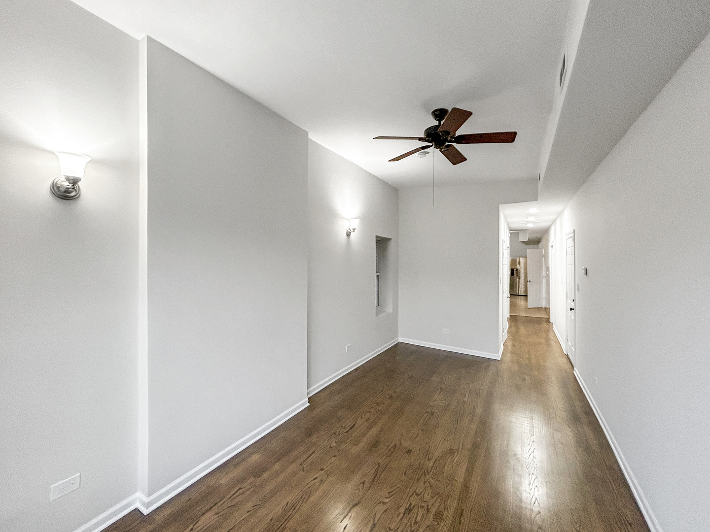 2953 West Warren Boulevard, Unit 2 Chicago, IL 60612 - Photo 5 of 31 wooden floor in an empty room with a window