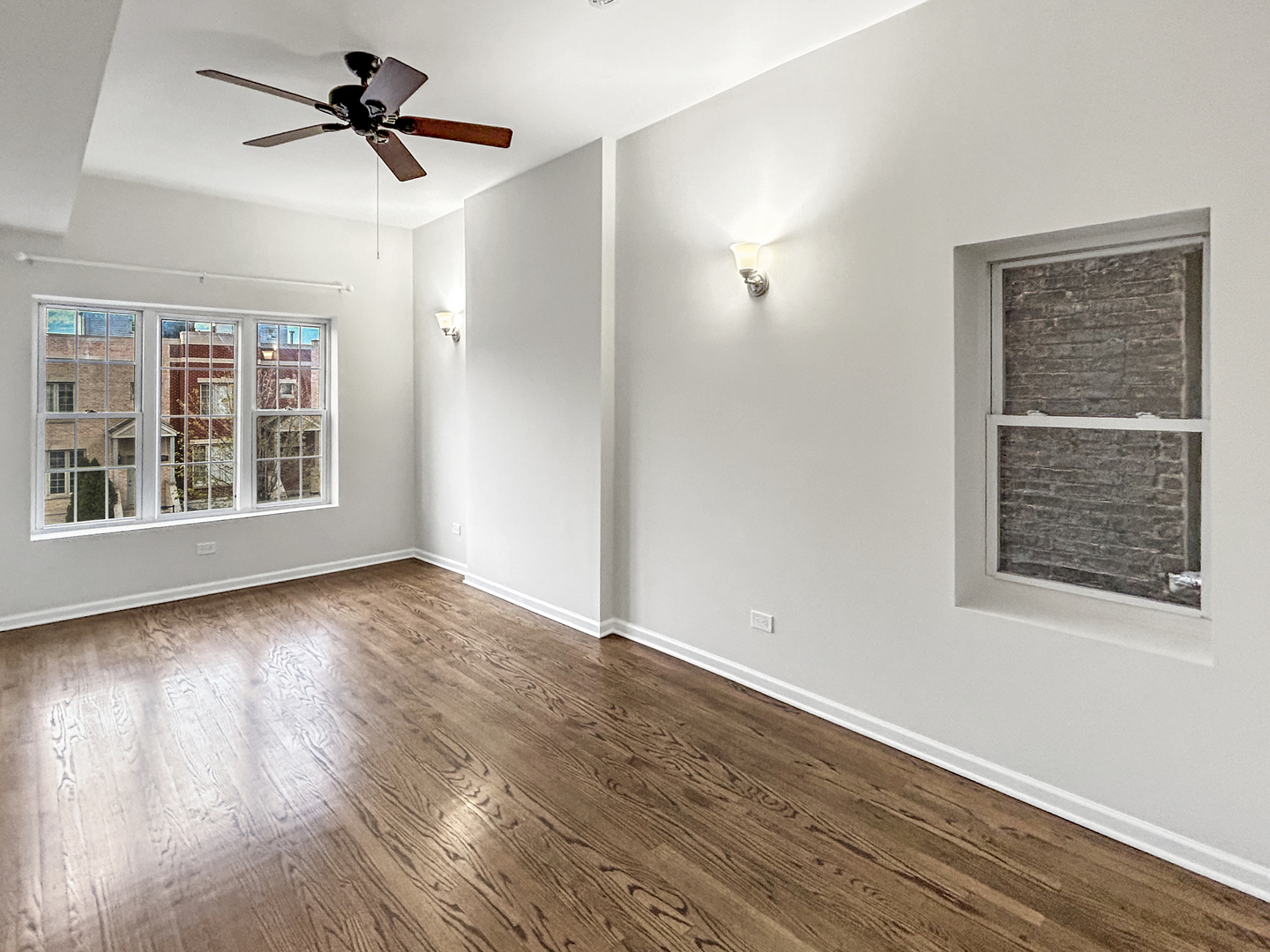 2953 West Warren Boulevard, Unit 2 Chicago, IL 60612 - Photo 6 of 31 a view of empty room with wooden floor and fan