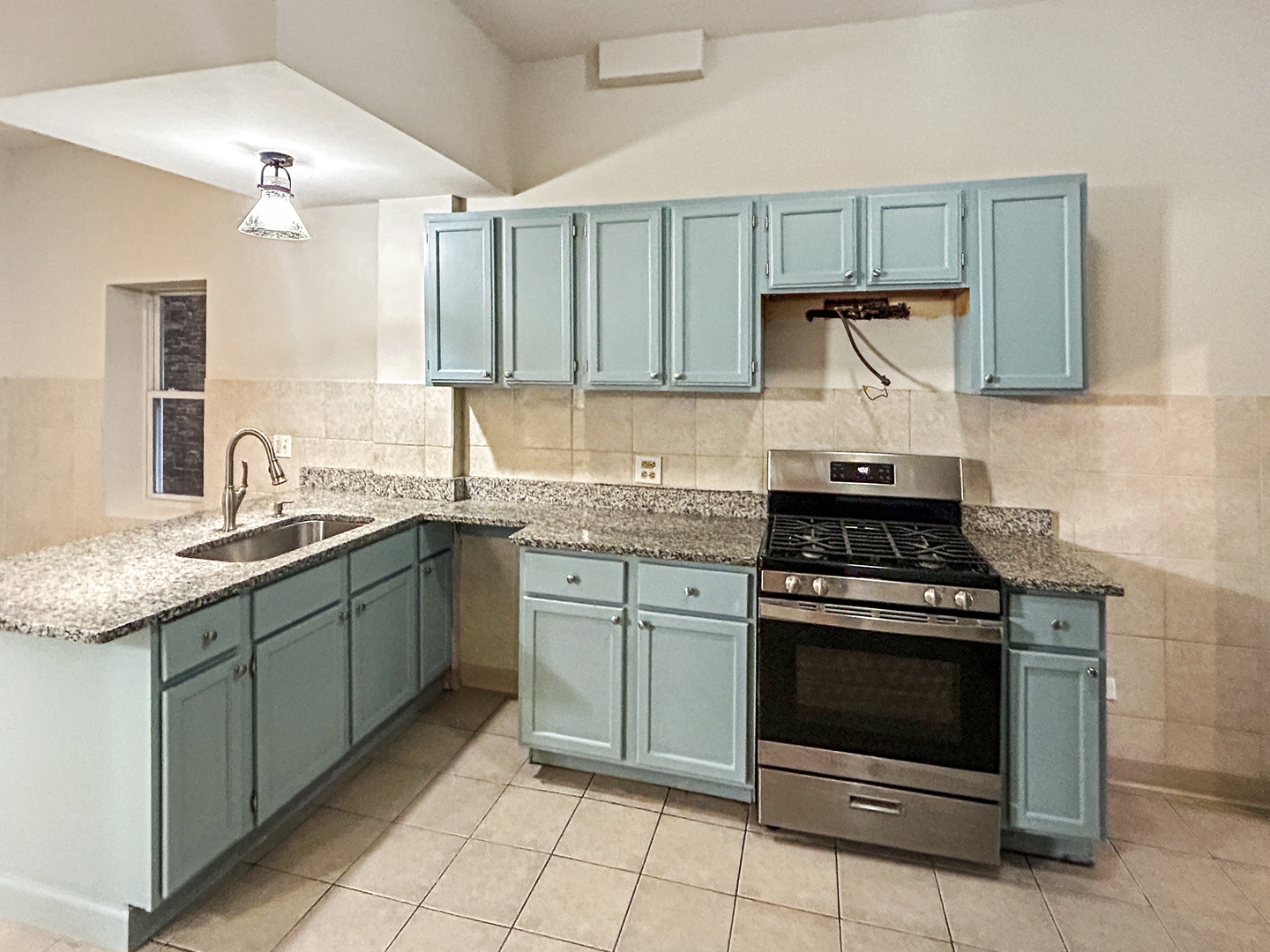 2953 West Warren Boulevard, Unit 2 Chicago, IL 60612 - Photo 9 of 31 a kitchen with a stove sink and cabinets