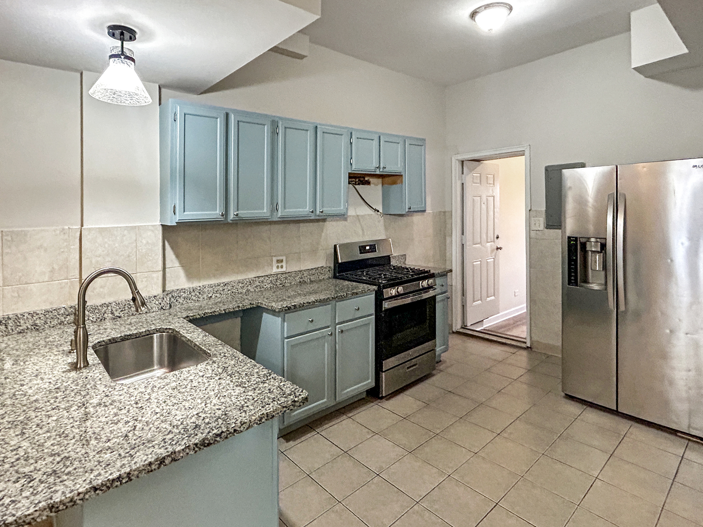 2953 West Warren Boulevard, Unit 2 Chicago, IL 60612 - Photo 10 of 31 a kitchen with a sink cabinets and stainless steel appliances