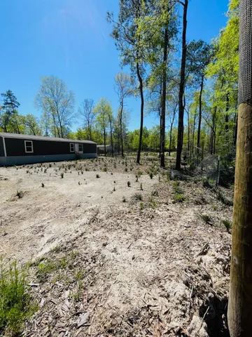 a view of a house with a yard covered with snow