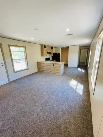a view of empty room with a fireplace