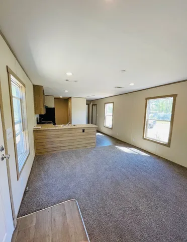 a kitchen with granite countertop a refrigerator a stove and wooden cabinets