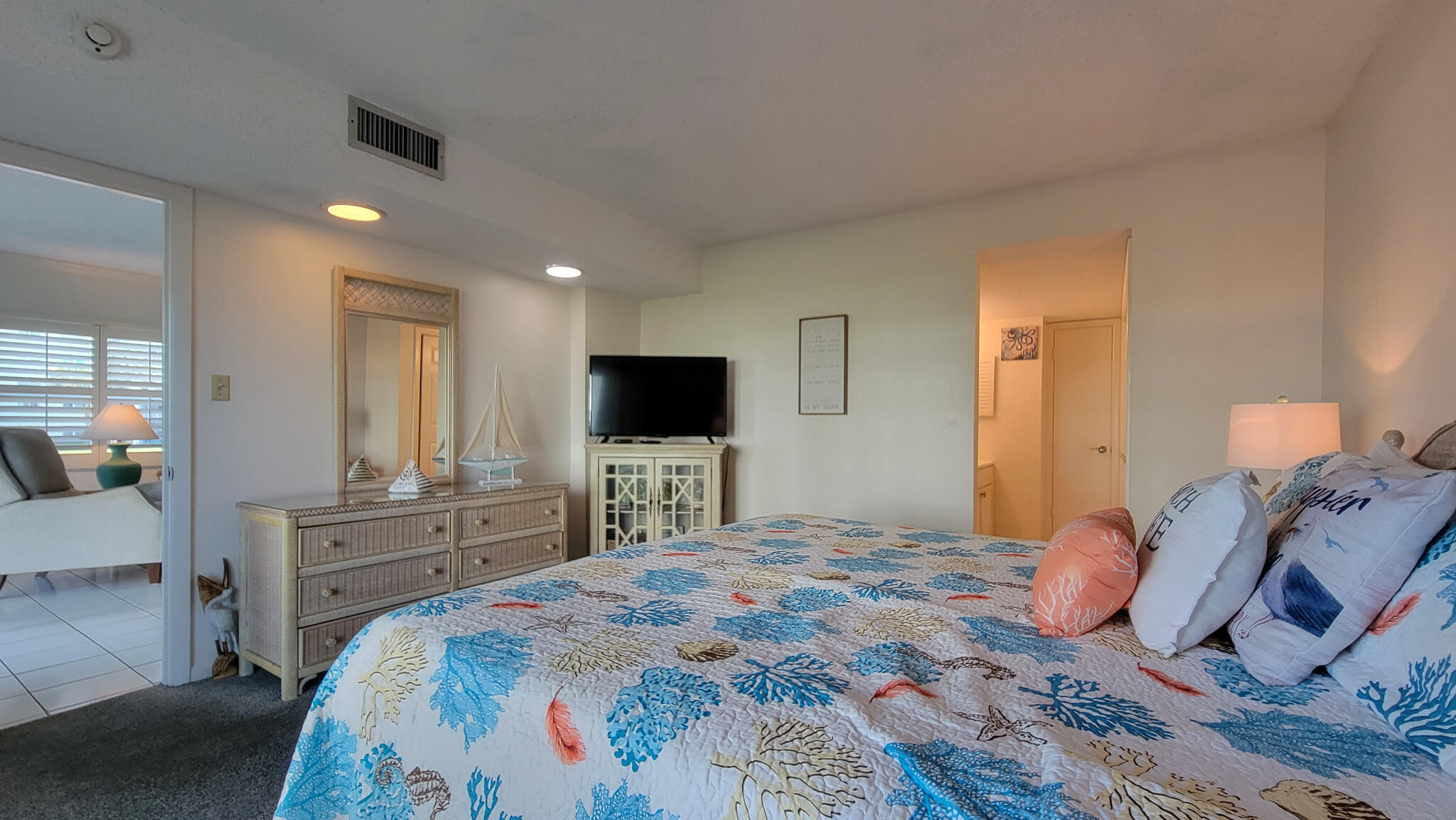909 Santa Rosa Boulevard, Unit 319 Fort Walton Beach, FL 32548 - Photo 12 of 39 a bedroom with a bed and a flat screen tv