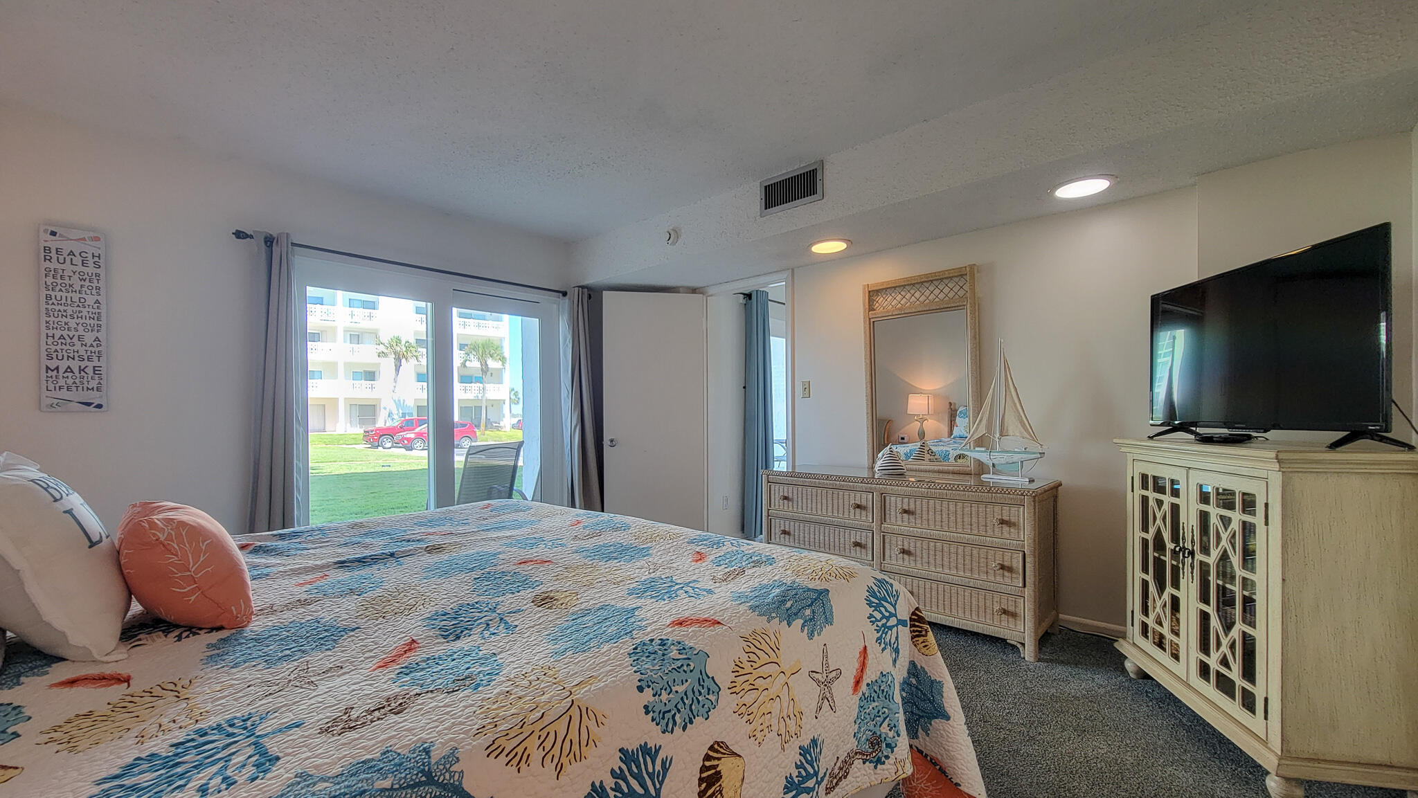 909 Santa Rosa Boulevard, Unit 319 Fort Walton Beach, FL 32548 - Photo 13 of 39 a bedroom with a bed and a flat screen tv