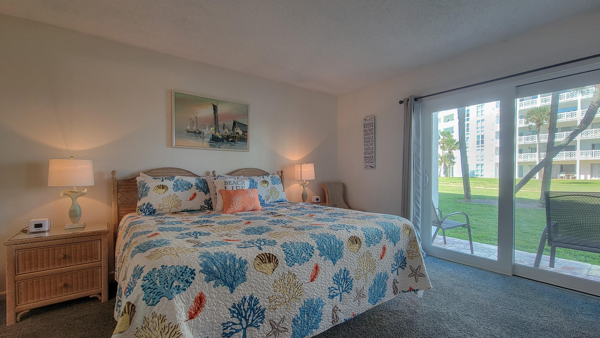 909 Santa Rosa Boulevard, Unit 319 Fort Walton Beach, FL 32548 - Photo 14 of 39 a bedroom with a bed and a lamp