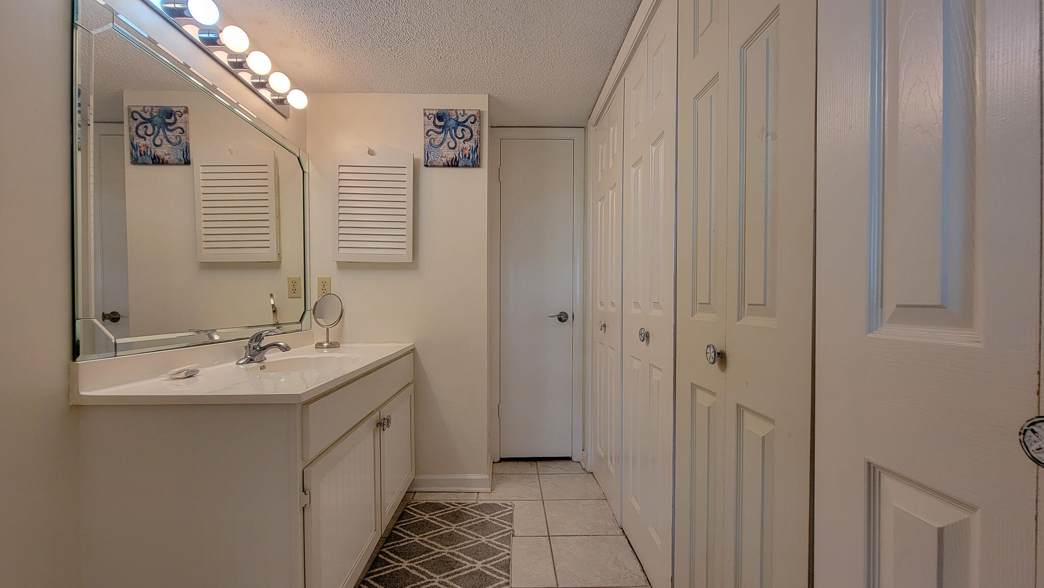 909 Santa Rosa Boulevard, Unit 319 Fort Walton Beach, FL 32548 - Photo 16 of 39 a bathroom with a double vanity sink and a mirror