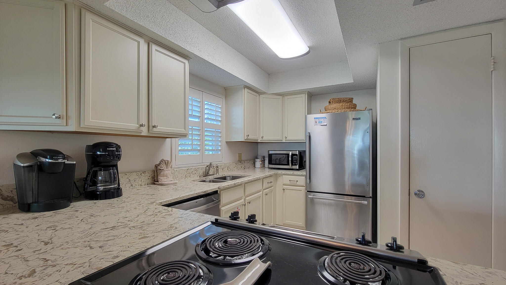 909 Santa Rosa Boulevard, Unit 319 Fort Walton Beach, FL 32548 - Photo 2 of 39 a kitchen with a refrigerator and a sink