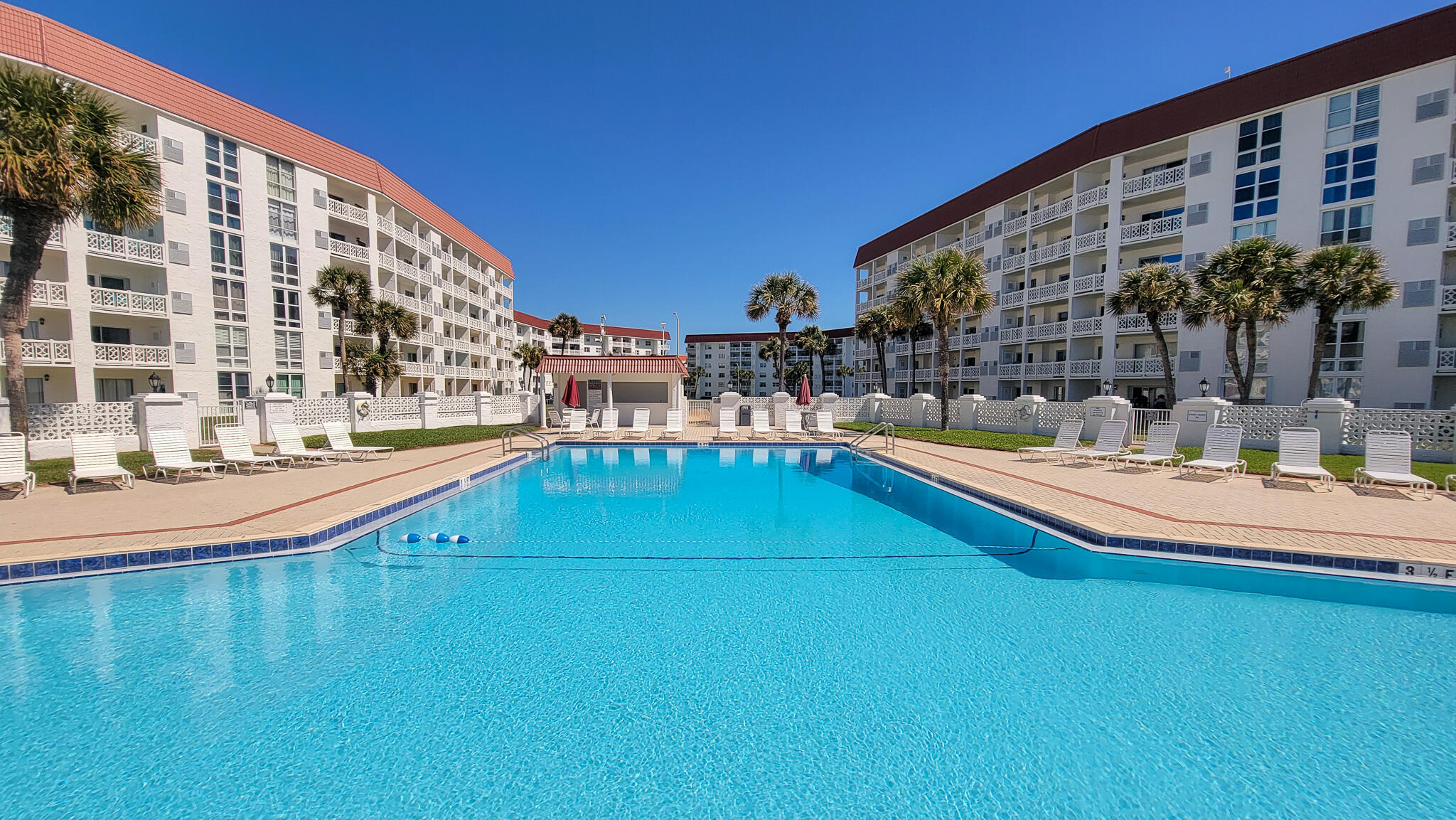 909 Santa Rosa Boulevard, Unit 319 Fort Walton Beach, FL 32548 - Photo 26 of 39 a view of a swimming pool with a lounge chairs