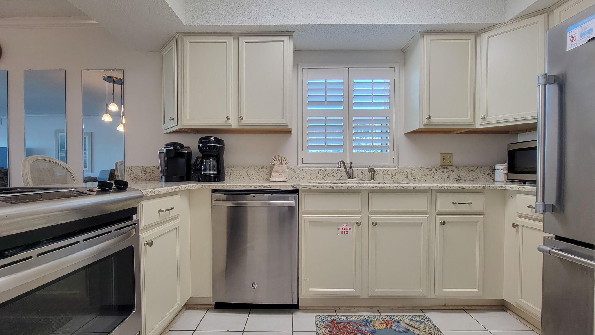 909 Santa Rosa Boulevard, Unit 319 Fort Walton Beach, FL 32548 - Photo 3 of 39 a kitchen with white cabinets and white appliances