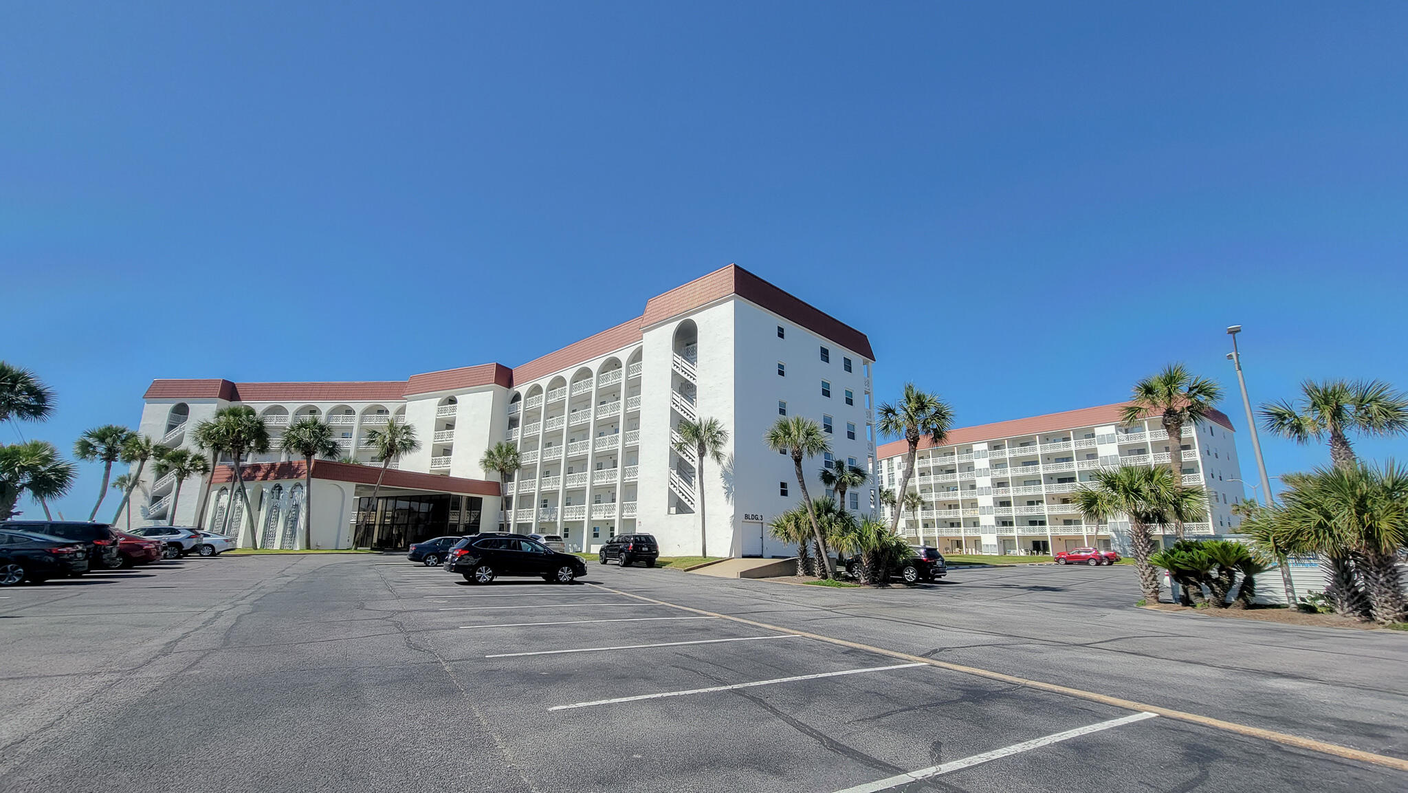 909 Santa Rosa Boulevard, Unit 319 Fort Walton Beach, FL 32548 - Photo 31 of 39 a building with trees in front of it