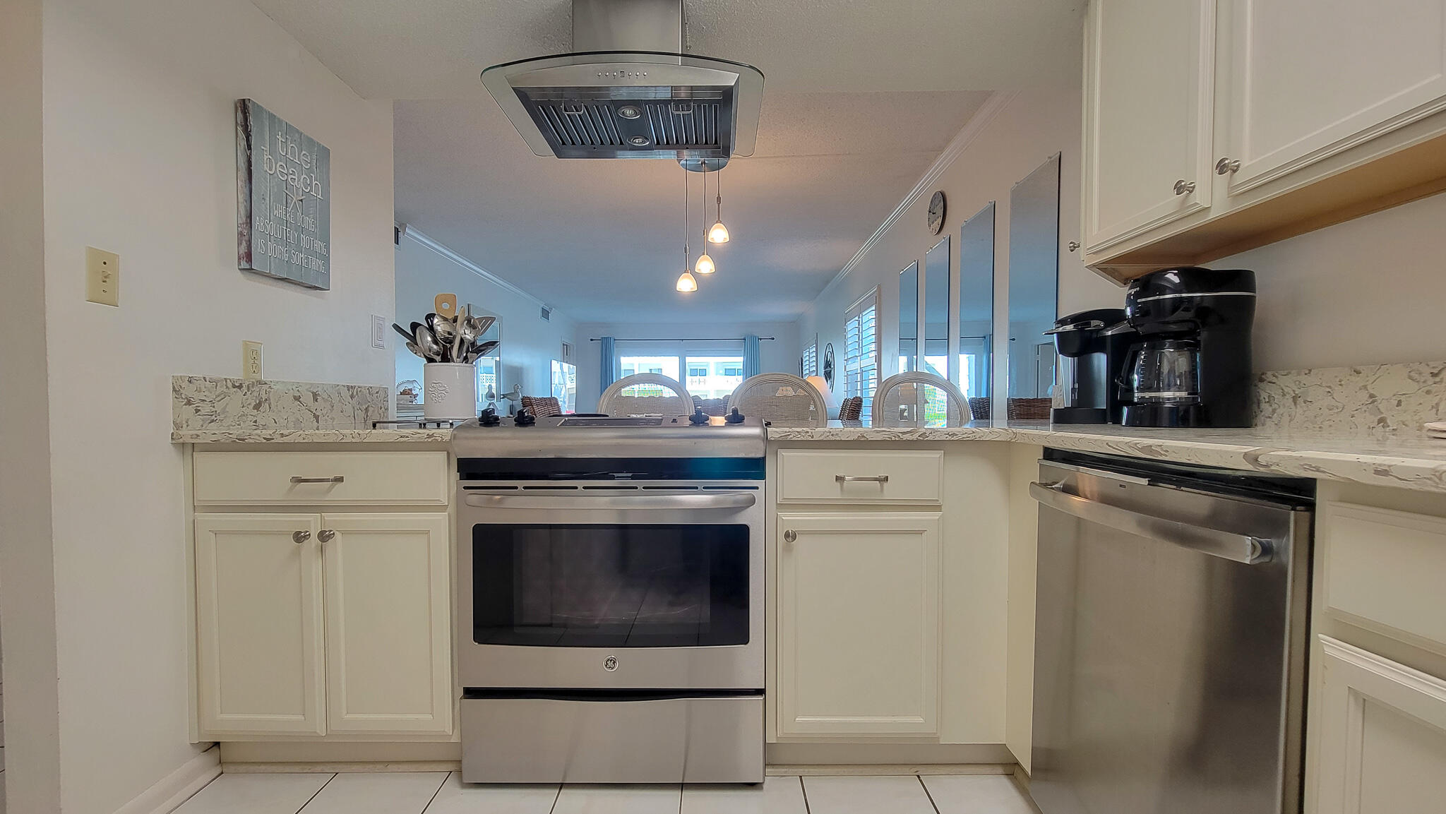 909 Santa Rosa Boulevard, Unit 319 Fort Walton Beach, FL 32548 - Photo 5 of 39 a kitchen with a stove and white cabinets