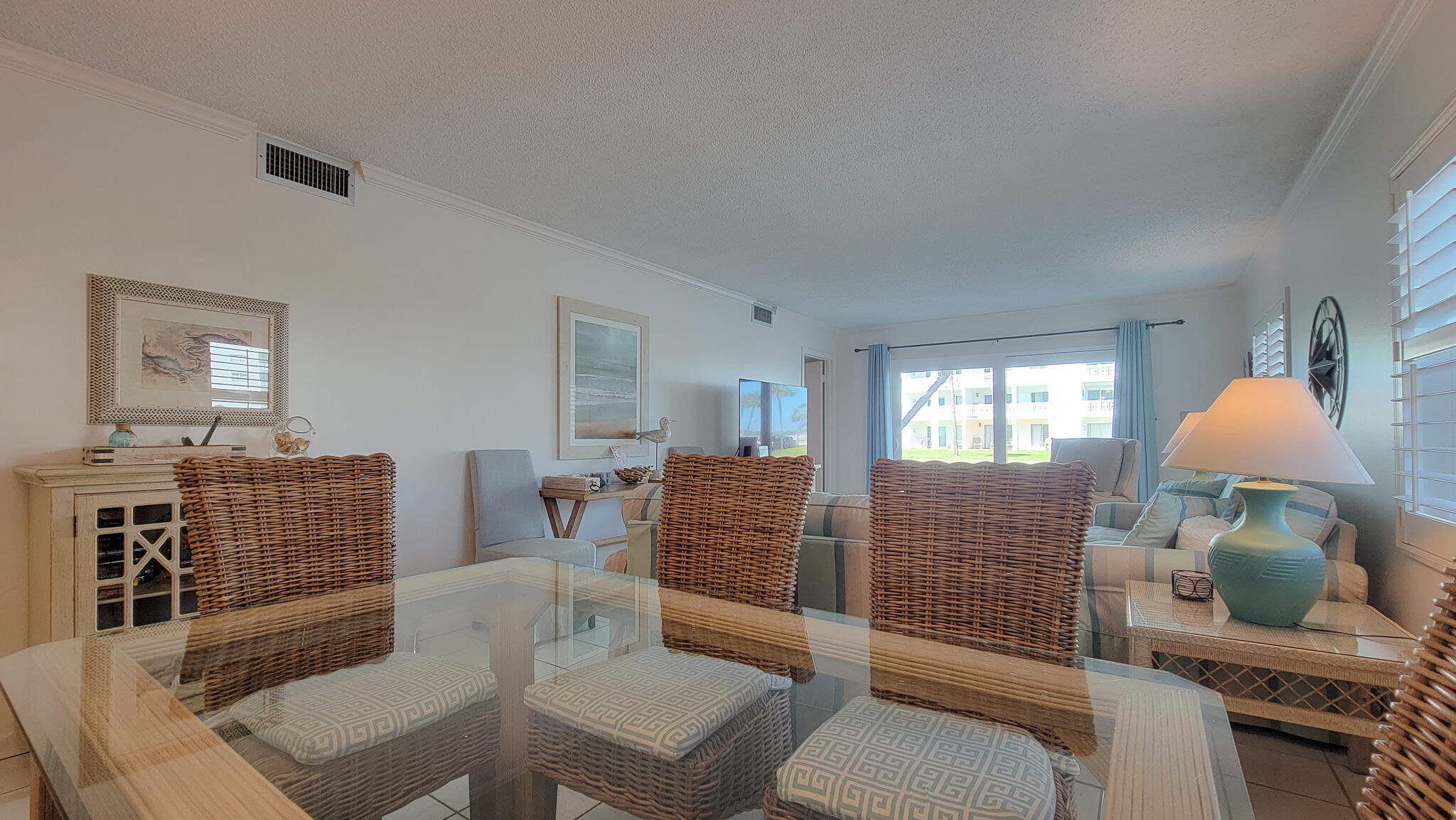 909 Santa Rosa Boulevard, Unit 319 Fort Walton Beach, FL 32548 - Photo 7 of 39 a living room with furniture and a flat screen tv