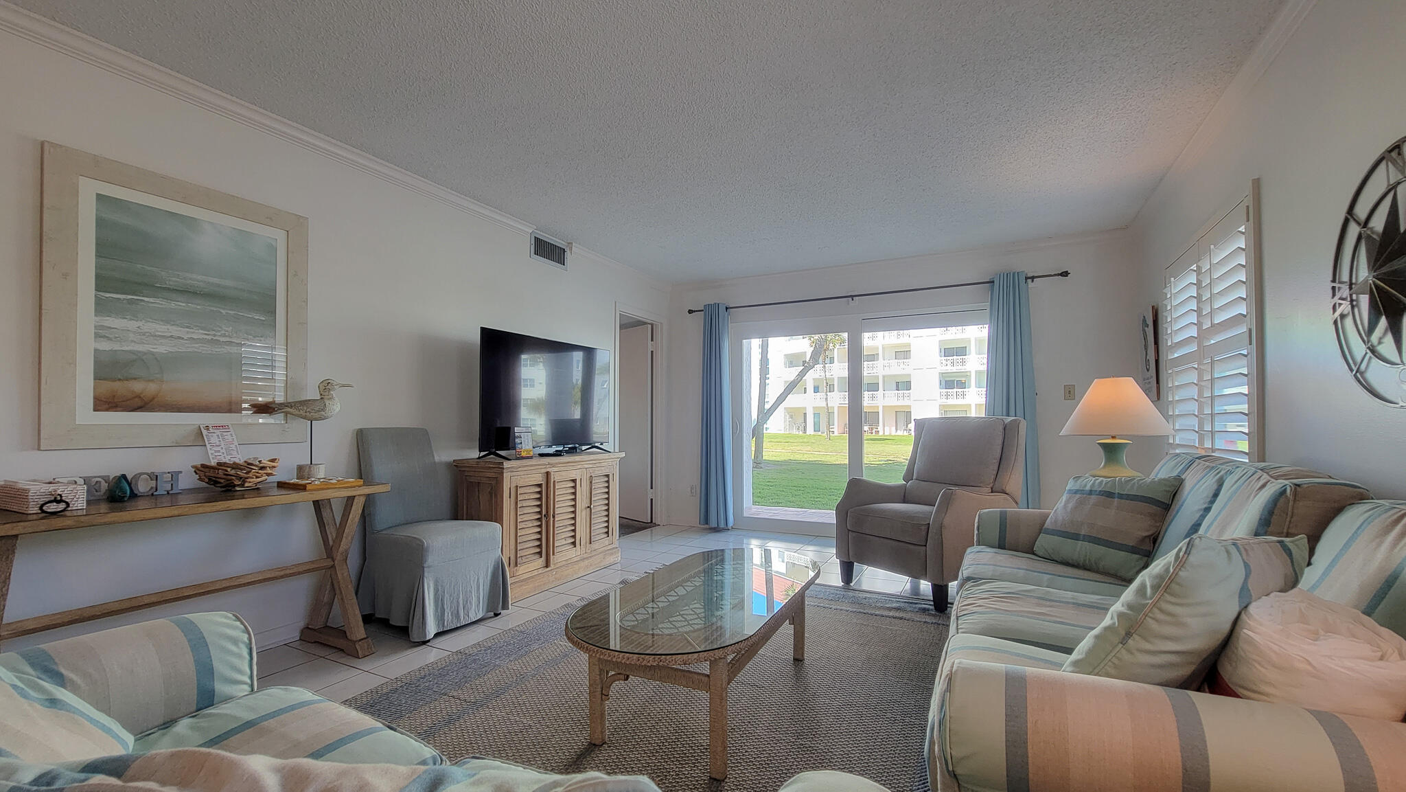 909 Santa Rosa Boulevard, Unit 319 Fort Walton Beach, FL 32548 - Photo 8 of 39 a living room with furniture and a flat screen tv