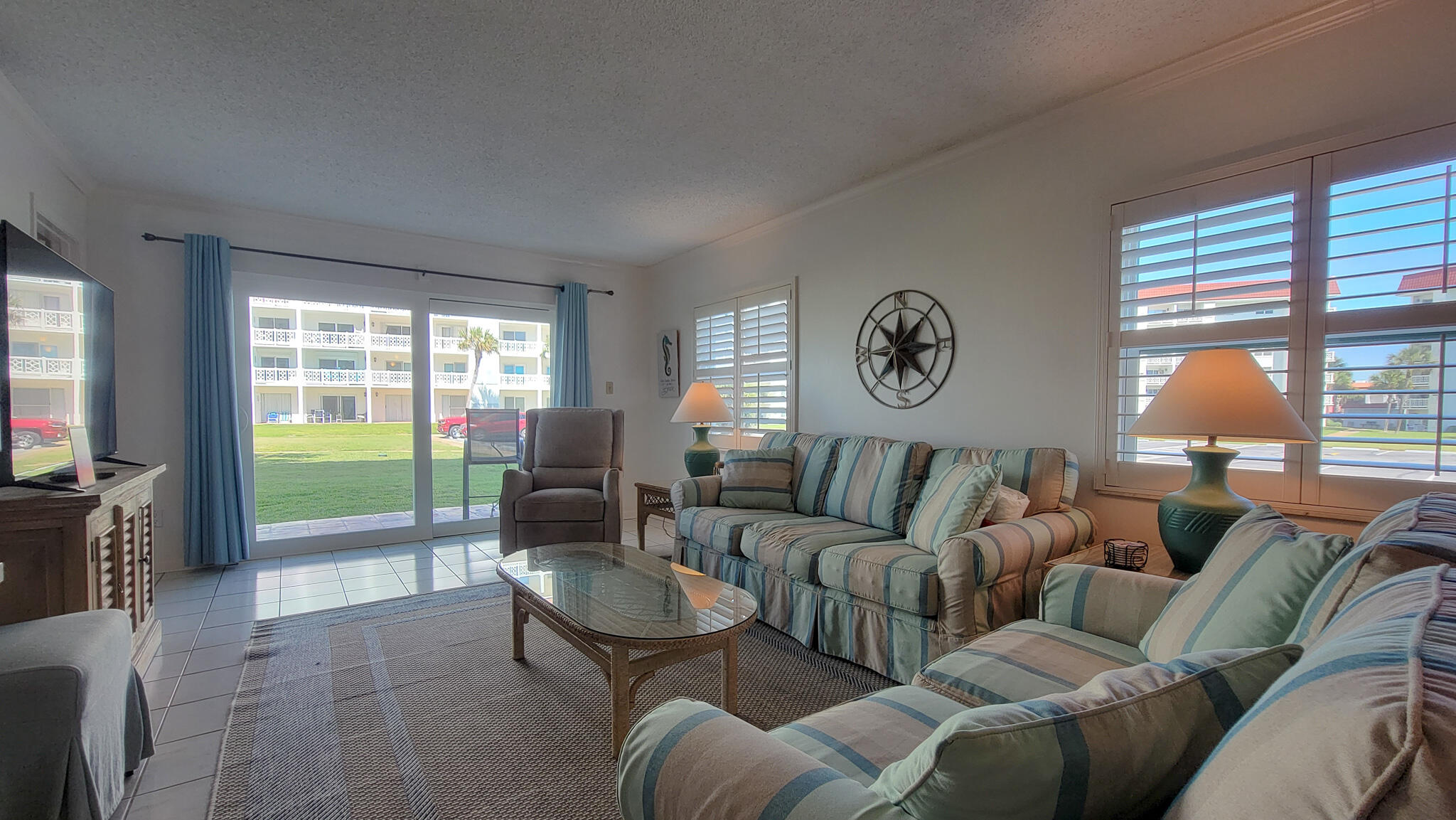 909 Santa Rosa Boulevard, Unit 319 Fort Walton Beach, FL 32548 - Photo 9 of 39 a living room with furniture and a large window