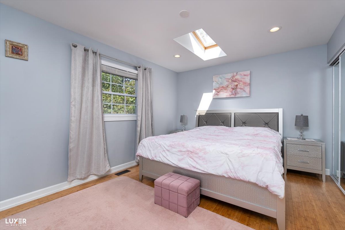 6908 Orchard Lane Hanover Park, IL 60133 - Photo 15 of 28 a bedroom with a bed and window