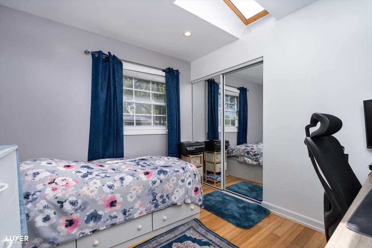 6908 Orchard Lane Hanover Park, IL 60133 - Photo 17 of 28 a bedroom with a bed and wooden floor