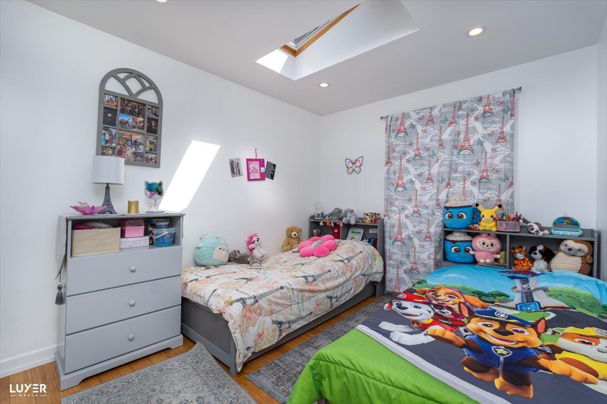 6908 Orchard Lane Hanover Park, IL 60133 - Photo 18 of 28 a bedroom with bed and window