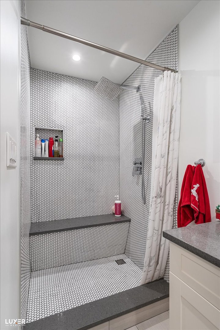 6908 Orchard Lane Hanover Park, IL 60133 - Photo 23 of 28 a bathroom with a shower and a bathtub