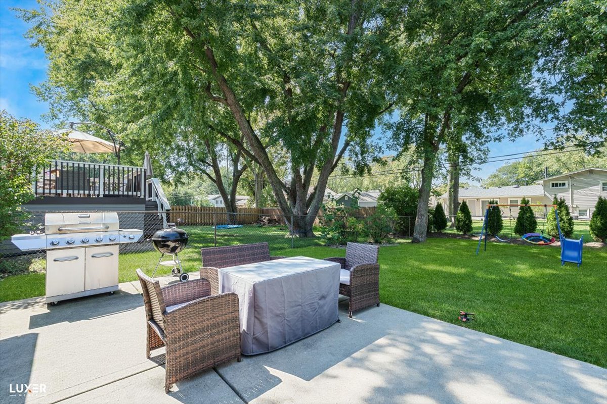 6908 Orchard Lane Hanover Park, IL 60133 - Photo 27 of 28 a view of backyard with swimming pool and green space