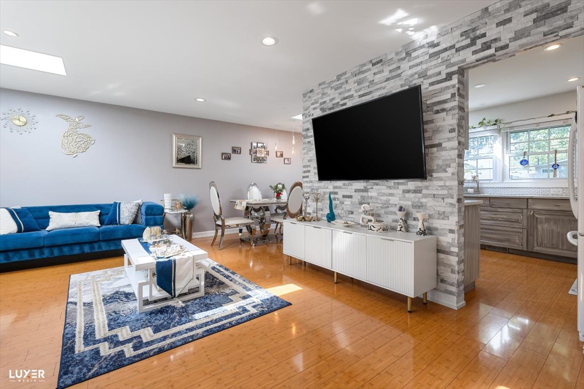 6908 Orchard Lane Hanover Park, IL 60133 - Photo 7 of 28 a living room with fireplace furniture and a flat screen tv