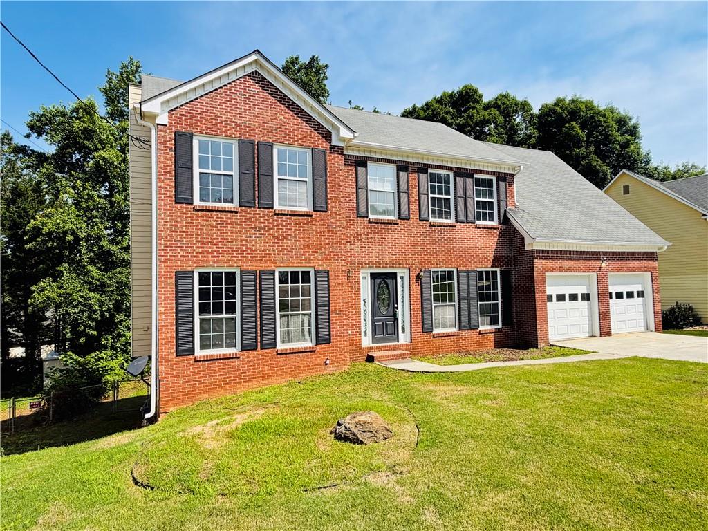 2205 Springer Walk Lawrenceville, GA 30043 - Photo 1 of 26 a front view of a house with a yard