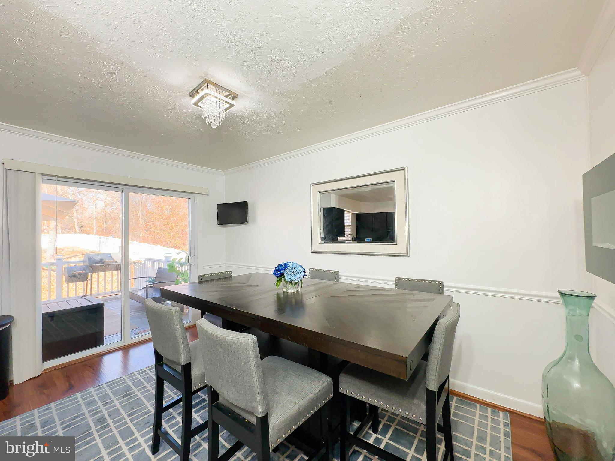 8504 Heatherwick Drive Brandywine, MD 20613 - Photo 13 of 51 a view of a dining room with furniture window and wooden floor
