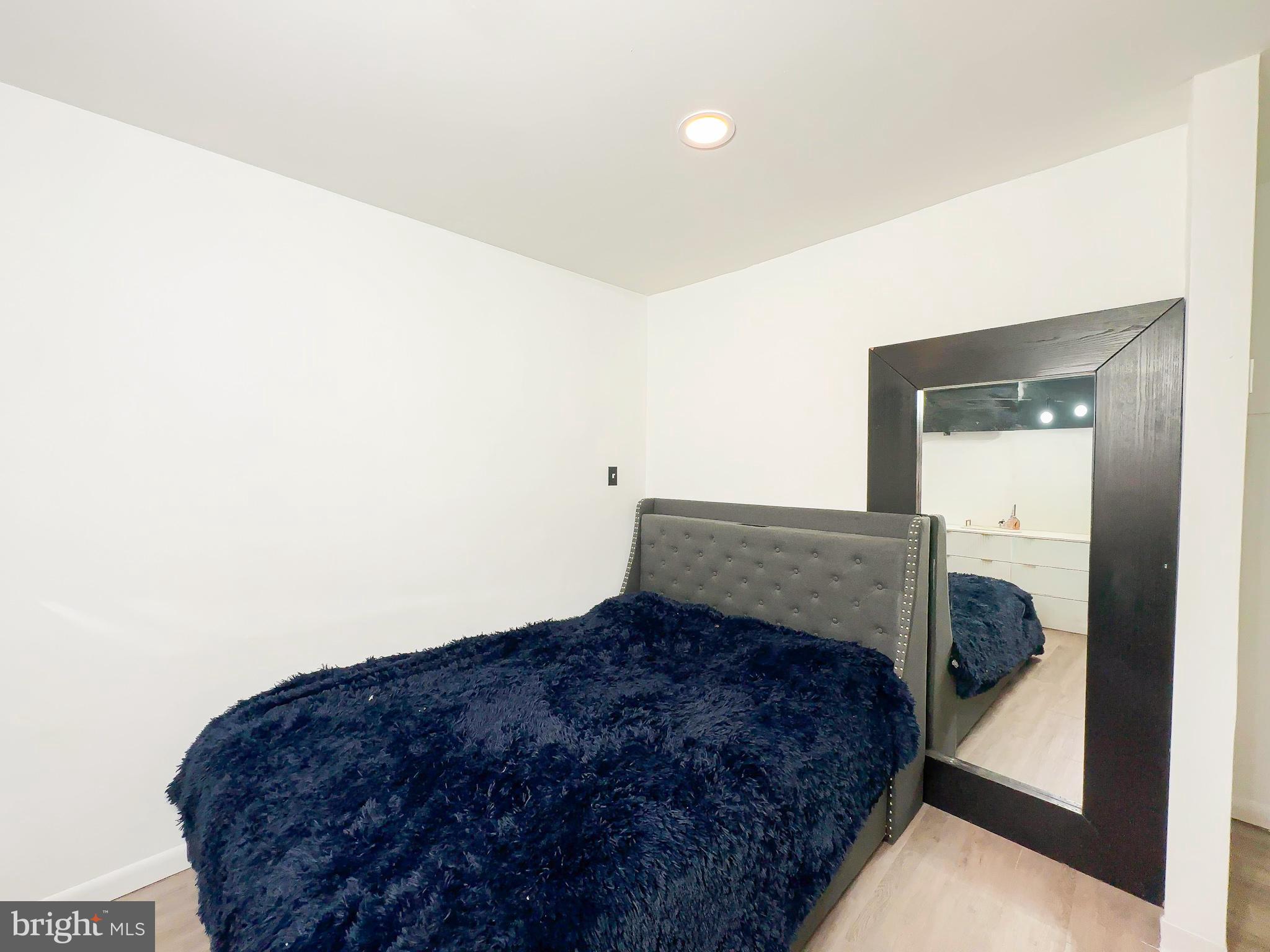 8504 Heatherwick Drive Brandywine, MD 20613 - Photo 31 of 51 a bedroom with a bed and a mirror