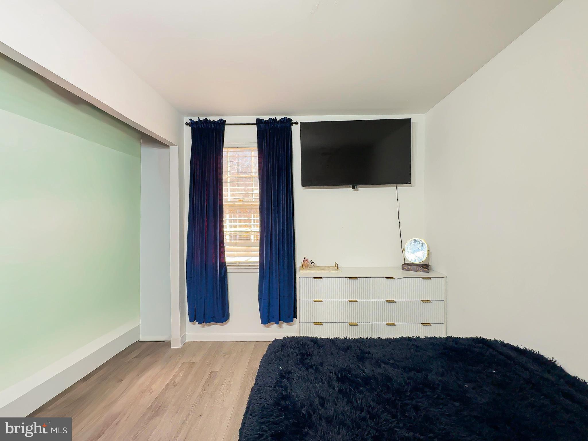 8504 Heatherwick Drive Brandywine, MD 20613 - Photo 33 of 51 a bedroom with a large window and a ceiling fan