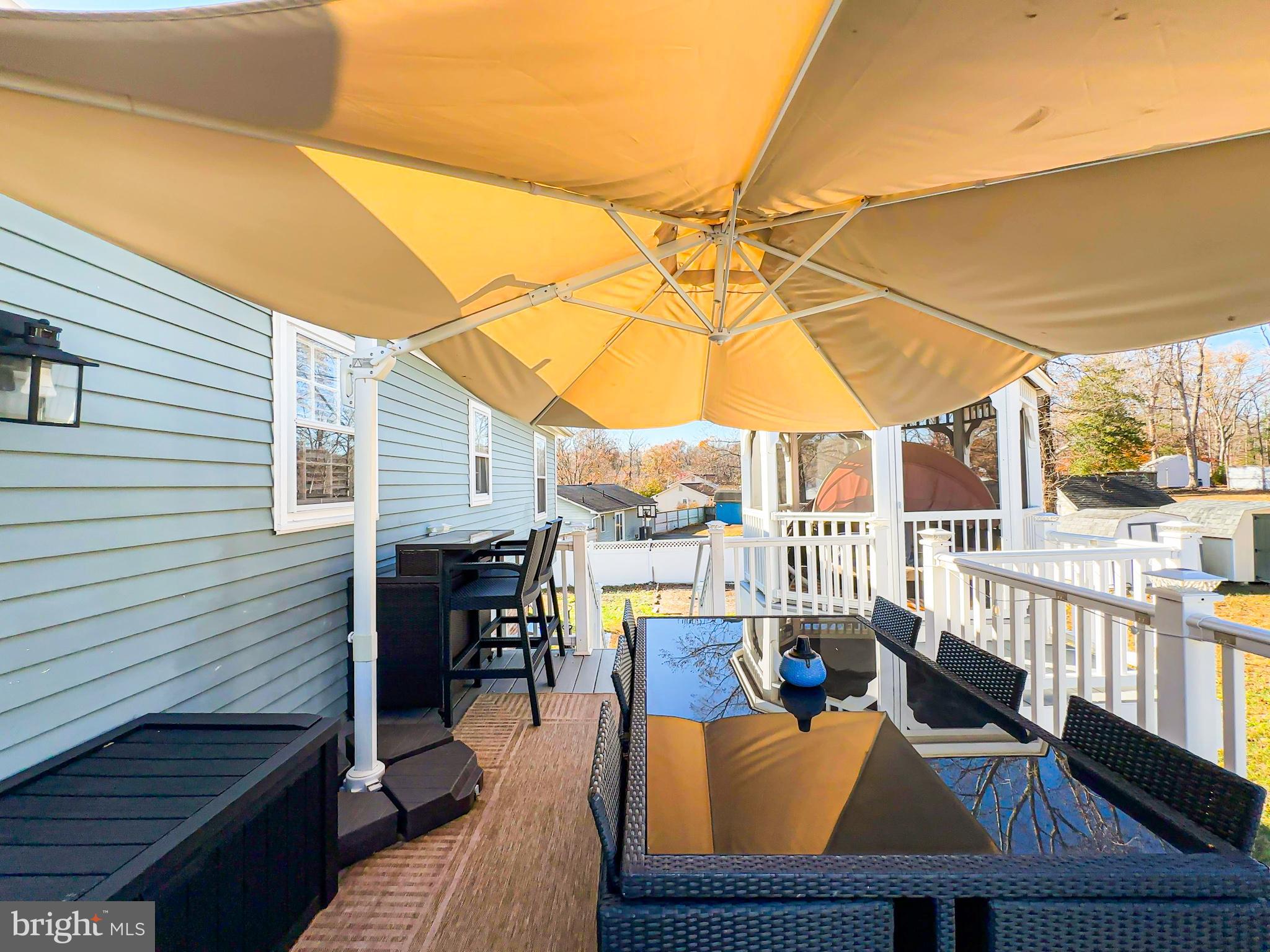 8504 Heatherwick Drive Brandywine, MD 20613 - Photo 38 of 51 a view of a patio with couches chairs potted plants and wooden floor