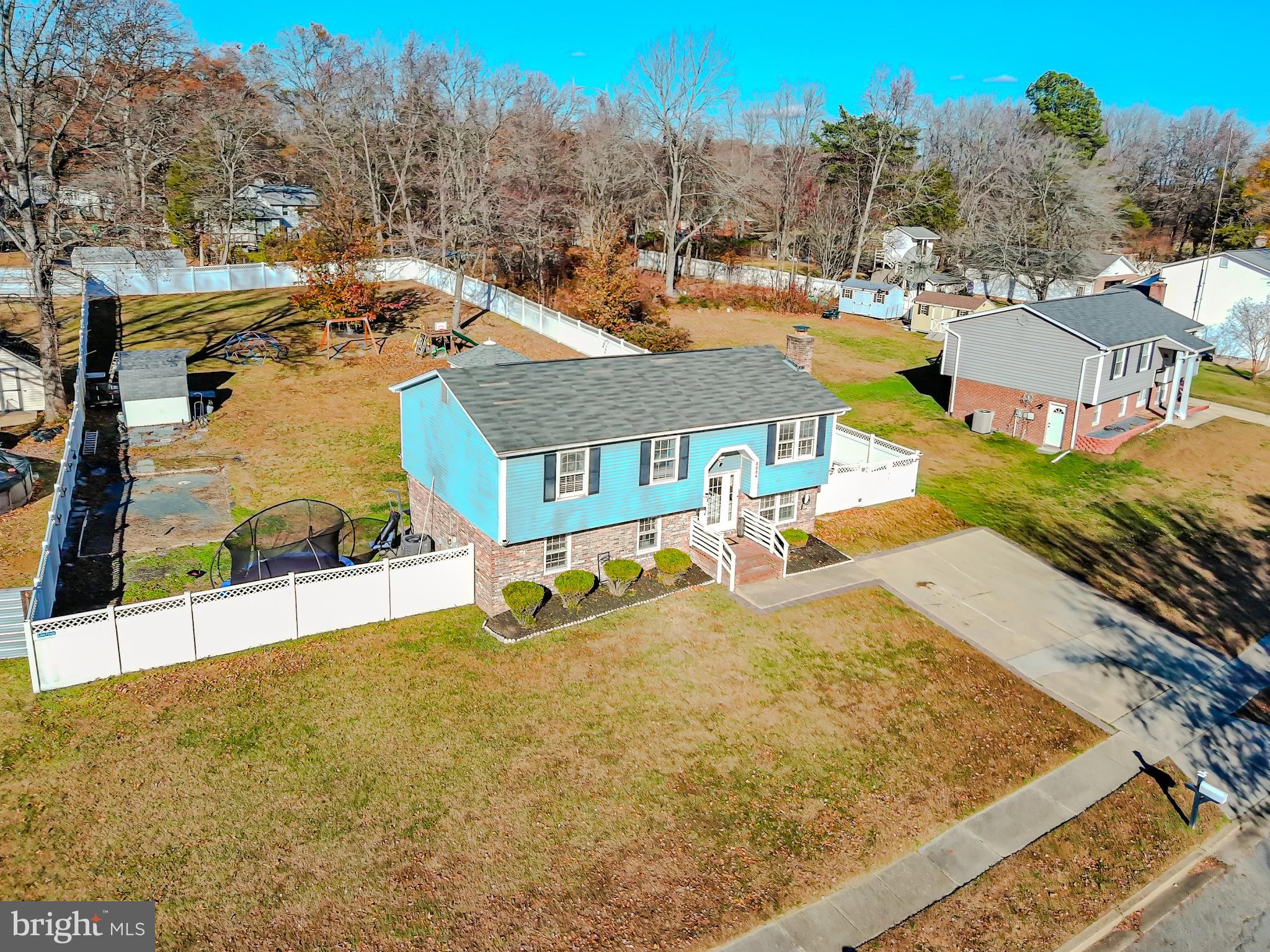 8504 Heatherwick Drive Brandywine, MD 20613 - Photo 45 of 51 a view of a swimming pool with a lawn chairs under an umbrella