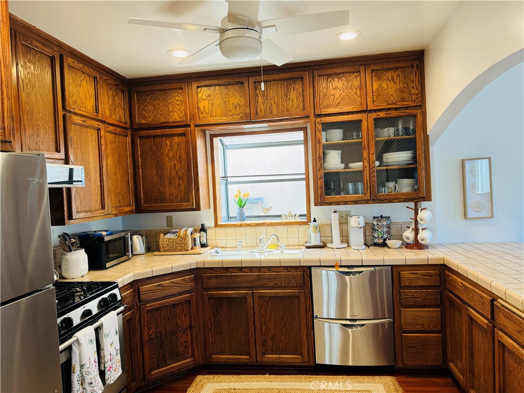 87 Rivo Alto Canal Long Beach, CA 90803 - Photo 5 of 30 a kitchen with stainless steel appliances granite countertop a sink stove and cabinets
