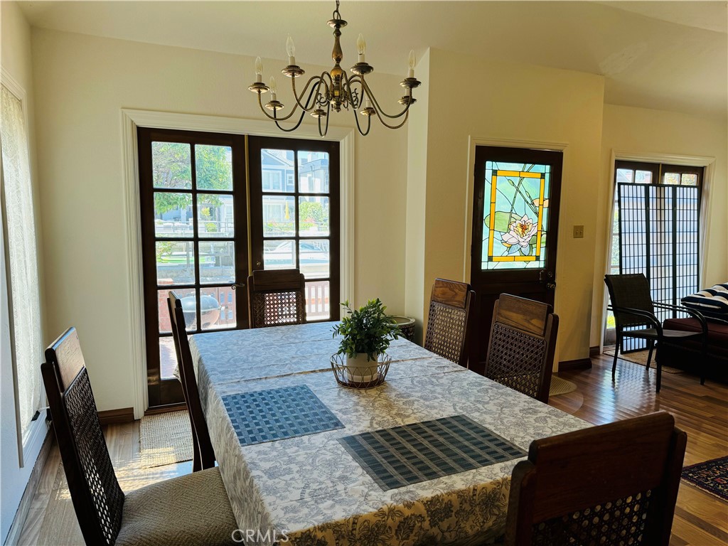 87 Rivo Alto Canal Long Beach, CA 90803 - Photo 9 of 30 a view of a dining room with furniture a chandelier and wooden floor