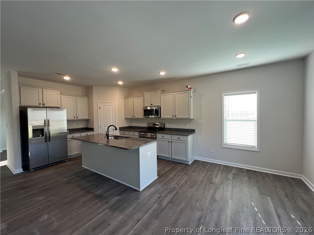 4075 Blue Springs Red Springs, NC 28377 - Photo 3 of 25 a kitchen with stainless steel appliances granite countertop a refrigerator a sink dishwasher a stove and a microwave oven on the wooden floor