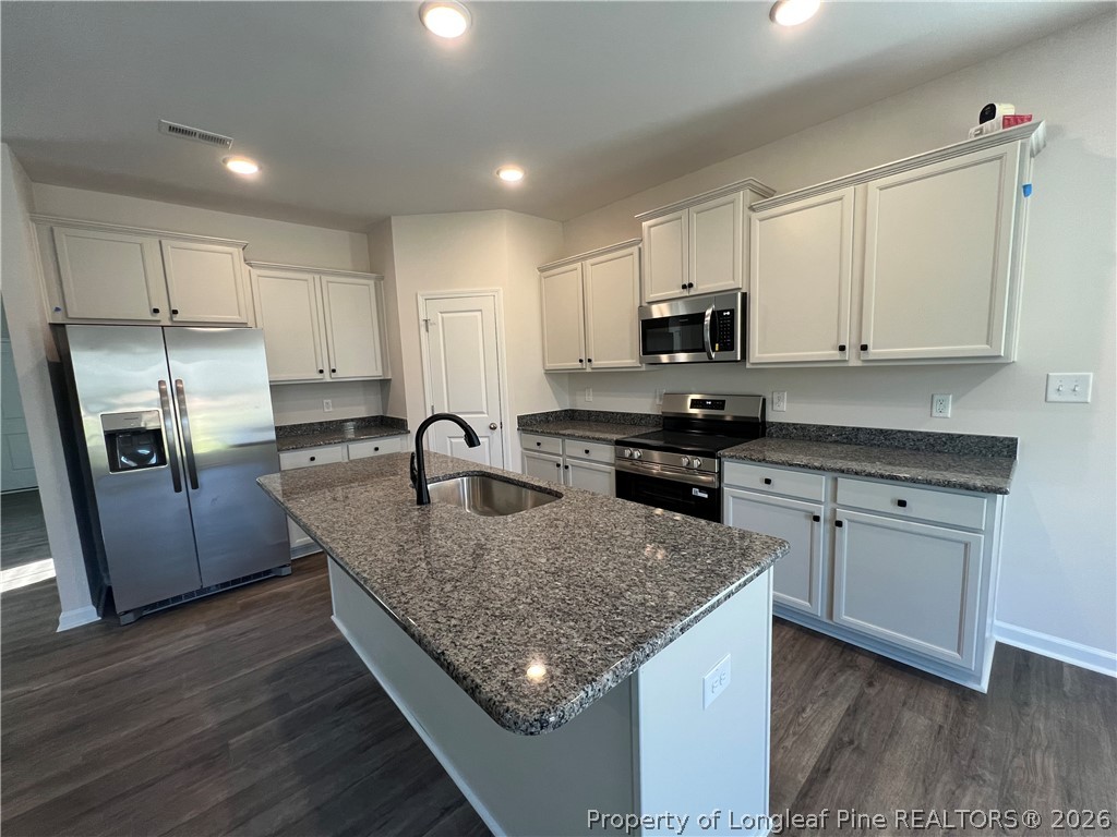 4075 Blue Springs Red Springs, NC 28377 - Photo 6 of 25 a kitchen with granite countertop a refrigerator stove and sink