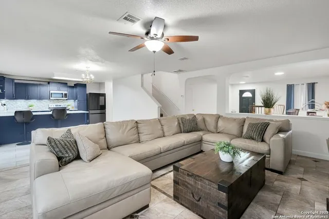 a living room with furniture and kitchen view