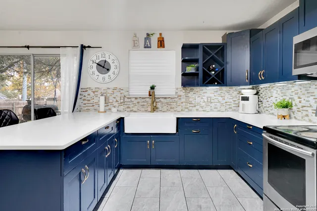 a kitchen with stainless steel appliances granite countertop a sink and wooden cabinets