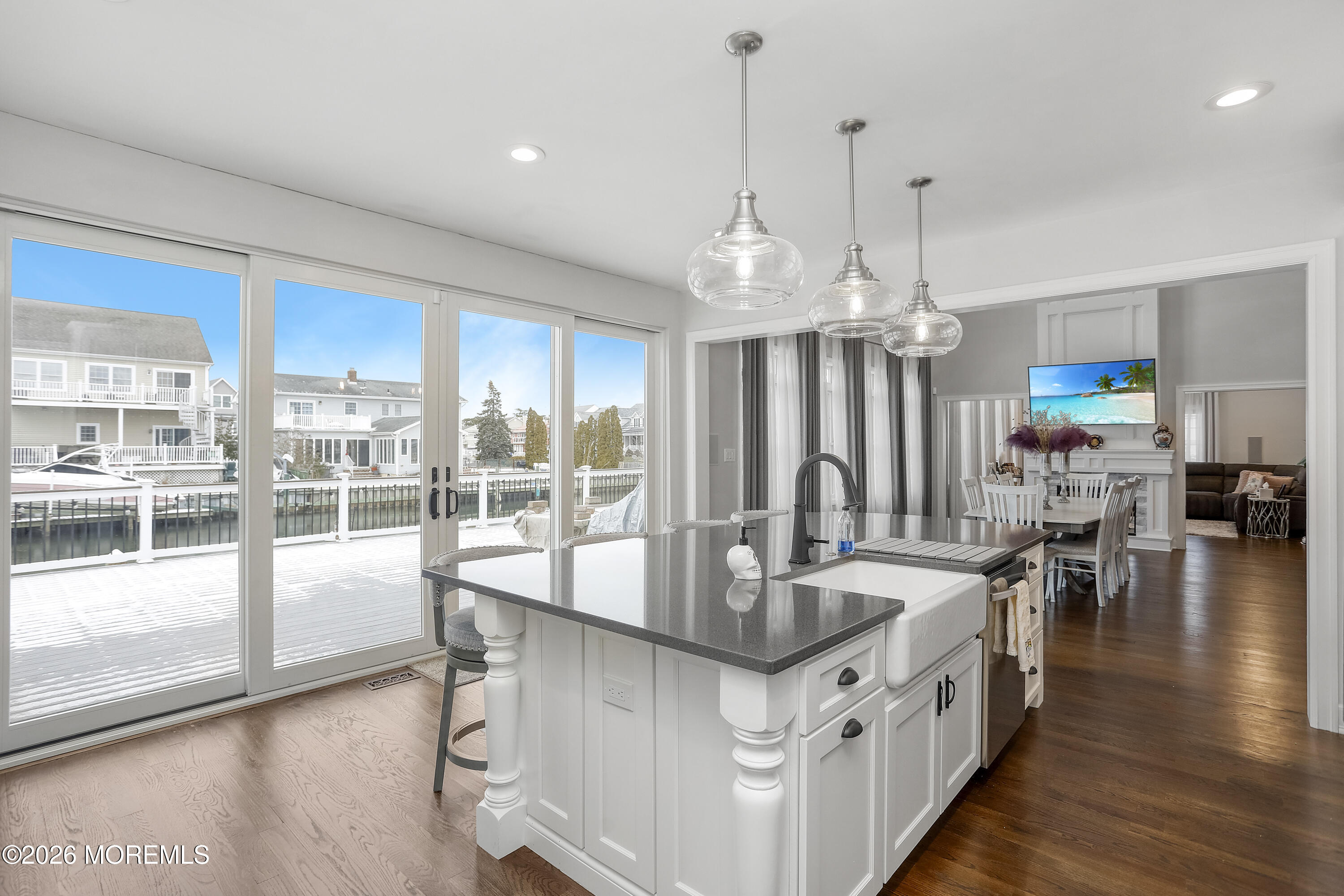 50 Neptune Road Toms River, NJ 08753 - Photo 16 of 73 a kitchen with stainless steel appliances granite countertop a sink a stove and a wooden floors