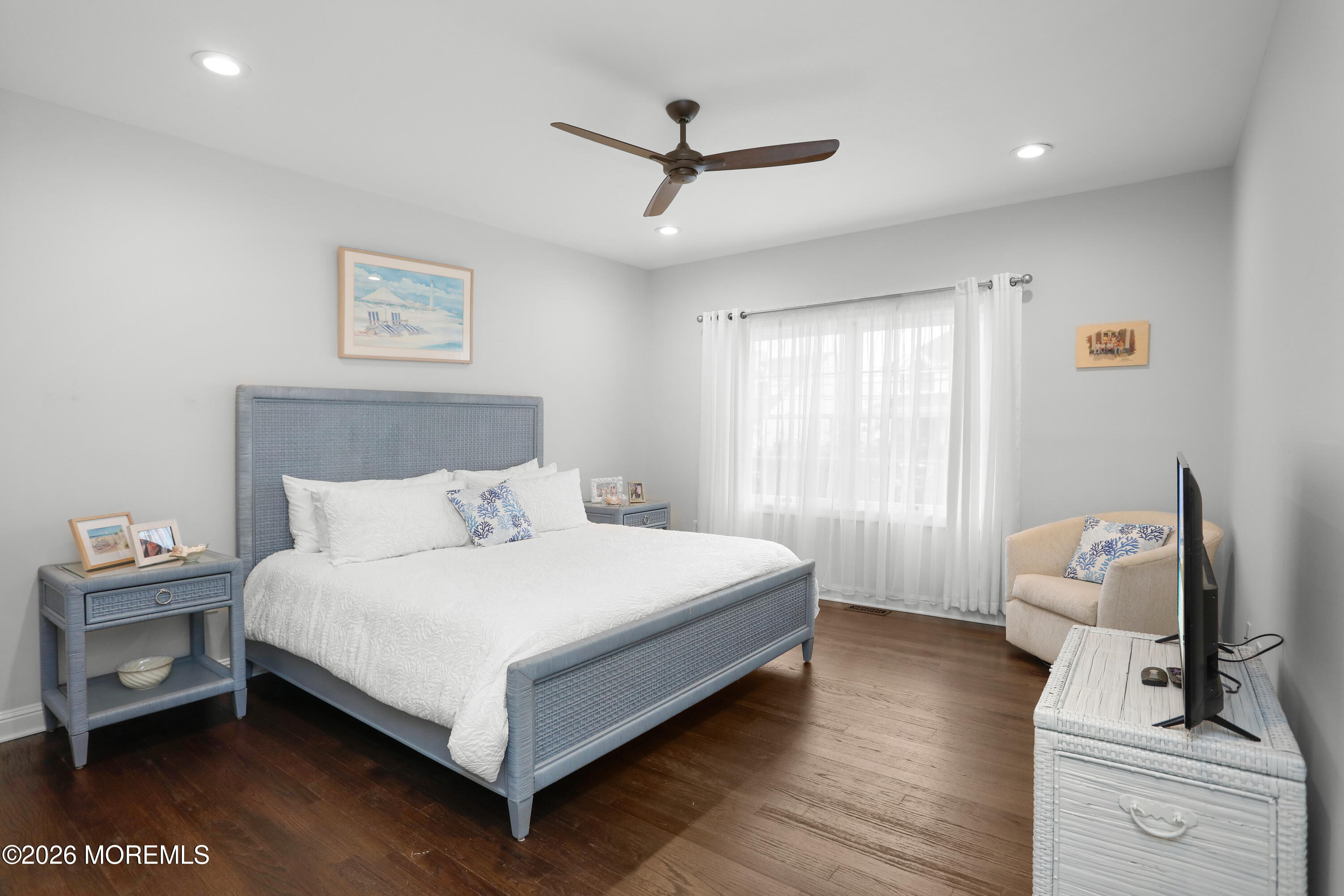 50 Neptune Road Toms River, NJ 08753 - Photo 32 of 73 a bedroom with a bed and a chandelier