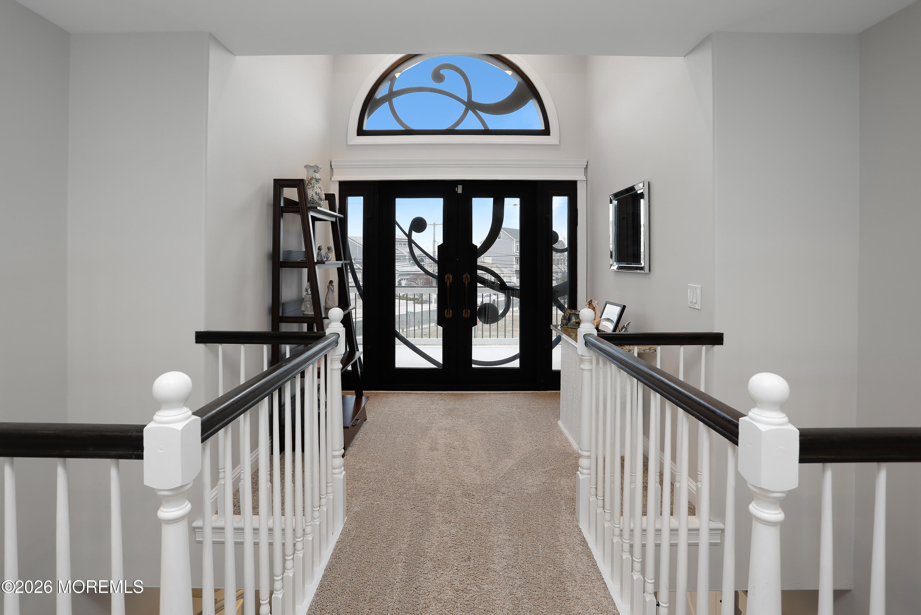 50 Neptune Road Toms River, NJ 08753 - Photo 38 of 73 a view of staircase with lots of frames on wall and a large window