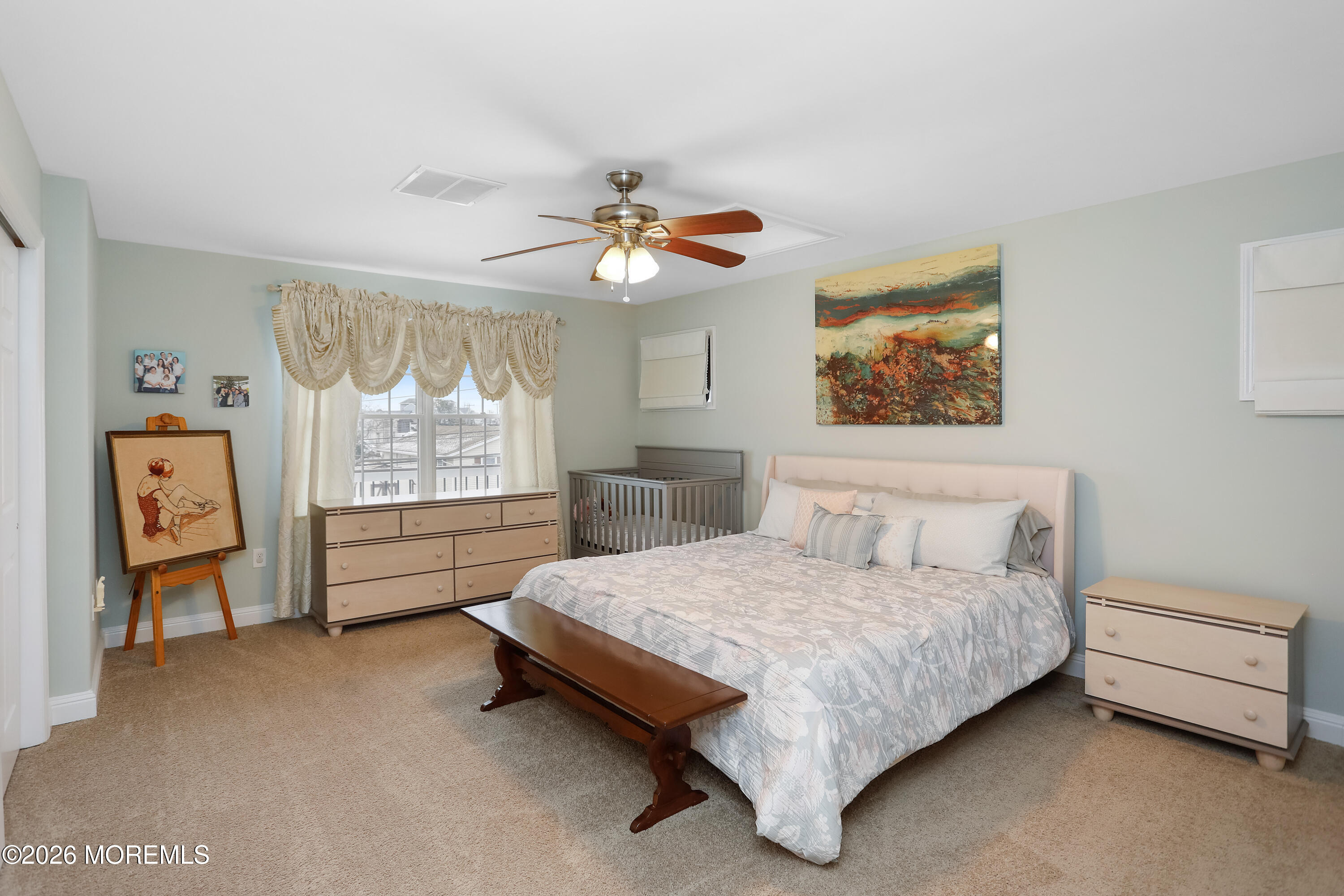 50 Neptune Road Toms River, NJ 08753 - Photo 43 of 73 a bedroom with a bed and a chandelier
