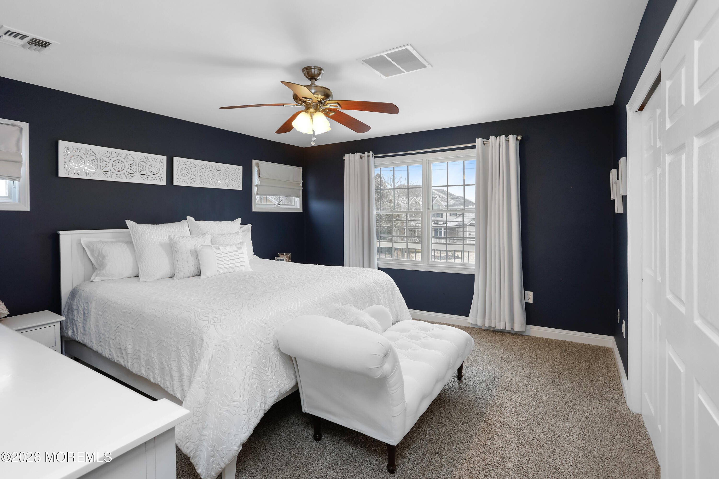 50 Neptune Road Toms River, NJ 08753 - Photo 44 of 73 a bedroom with a large bed and a chandelier