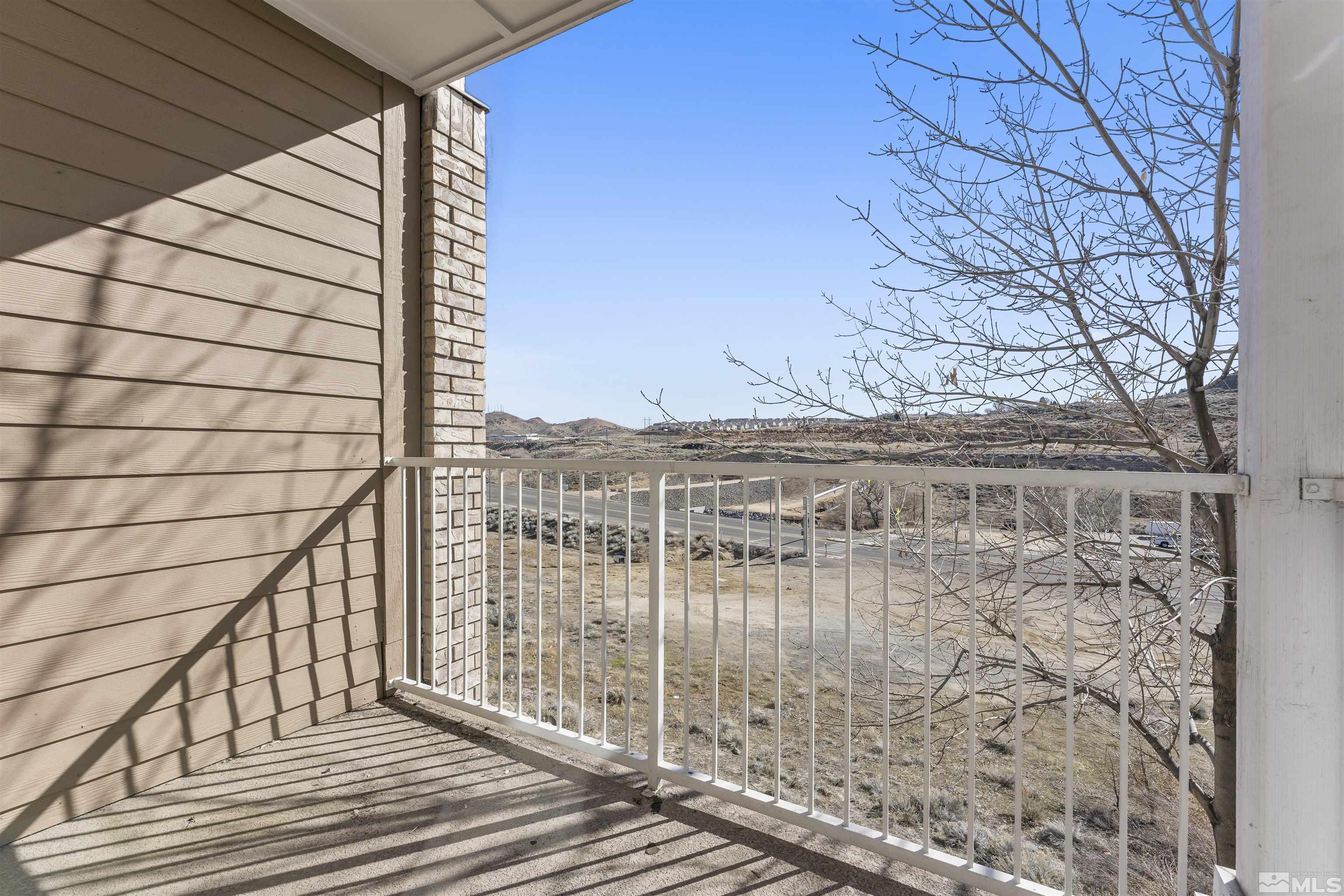200 Talus Way, Unit 212 Reno, NV 89503 - Photo 27 of 35 a view of balcony with wooden floor and fence