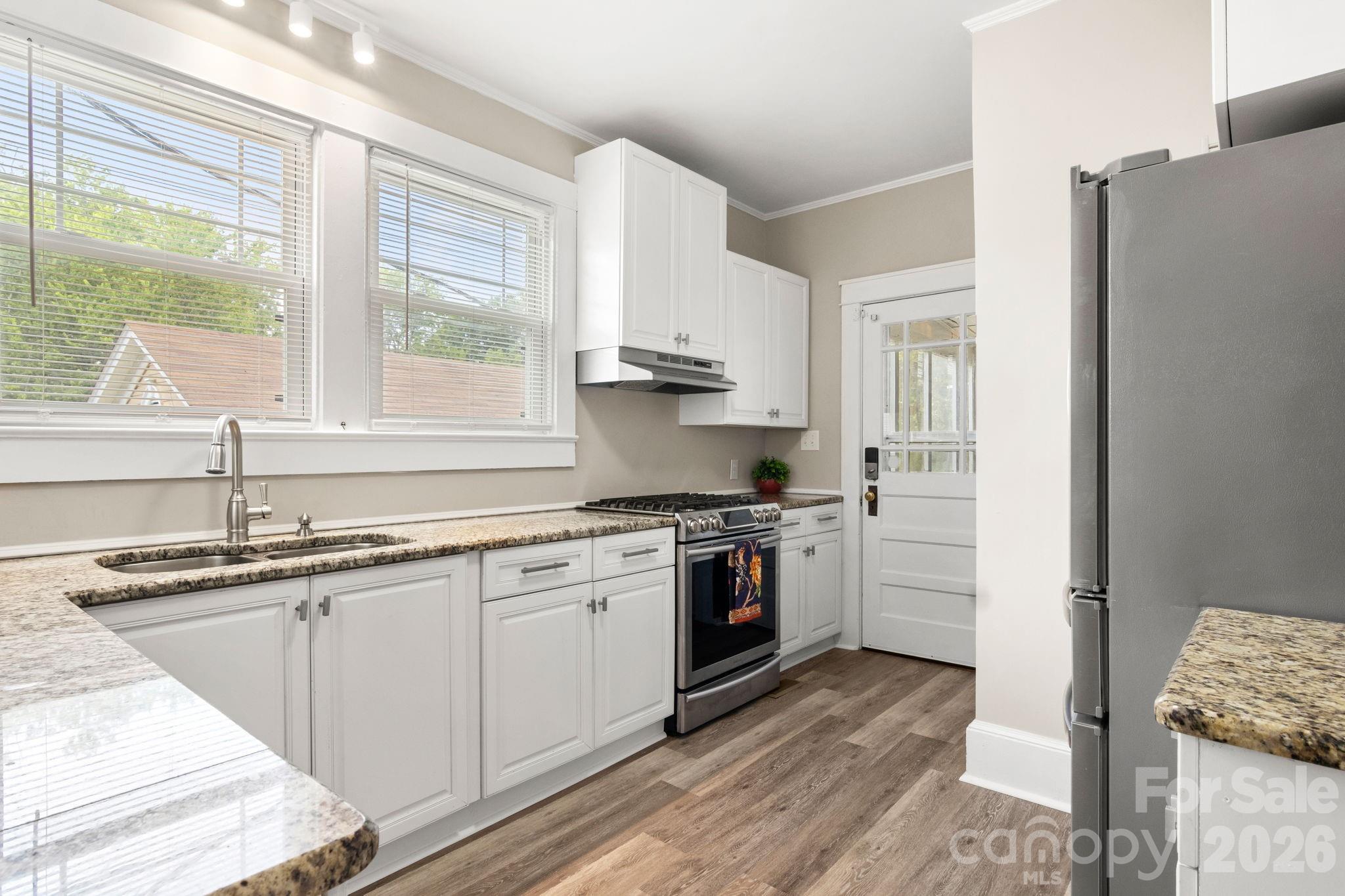108 Reedy Street Chester, SC 29706 - Photo 13 of 42 a kitchen with stainless steel appliances granite countertop a sink stove and refrigerator