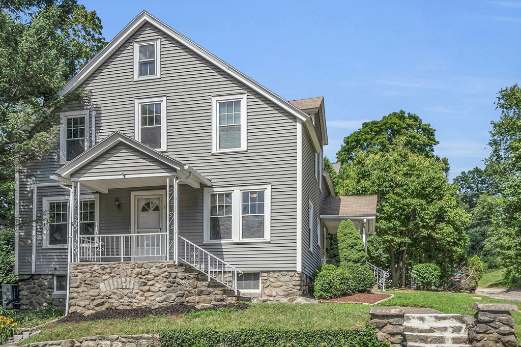 a front view of a house with a garden