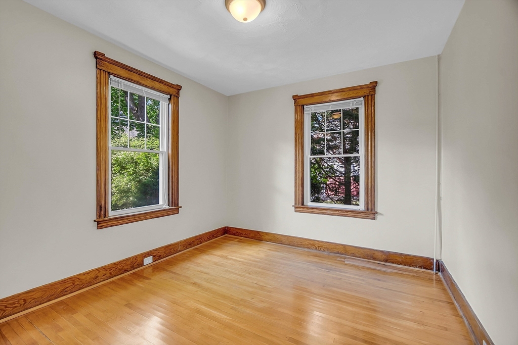5 Wakefield Street Worcester, MA 01605 - Photo 18 of 42 a view of an empty room with a window and wooden floor