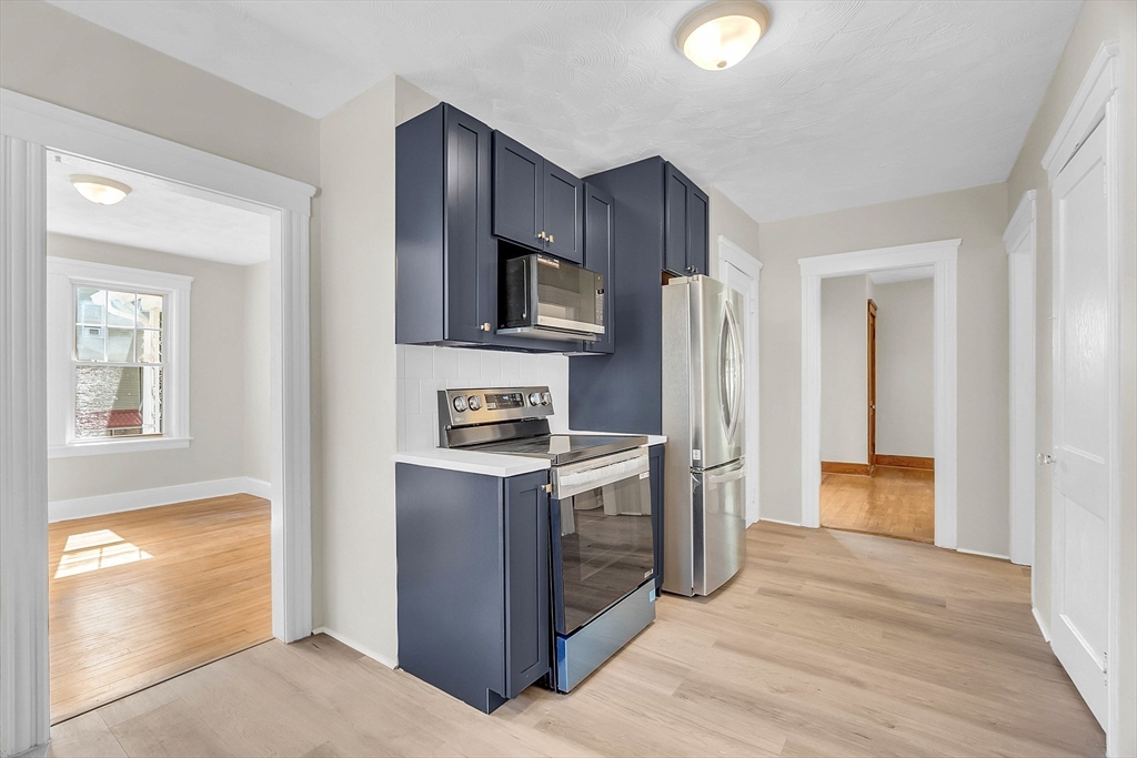 5 Wakefield Street Worcester, MA 01605 - Photo 19 of 42 a kitchen with stainless steel appliances granite countertop a refrigerator stove and sink