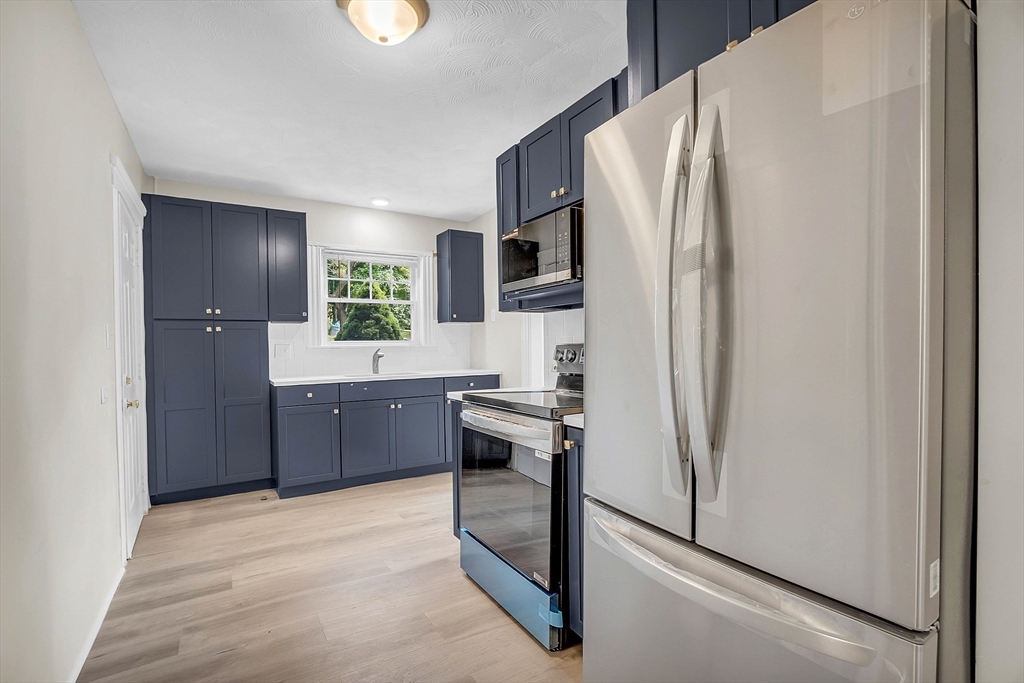 5 Wakefield Street Worcester, MA 01605 - Photo 20 of 42 a kitchen with stainless steel appliances a refrigerator and a stove top oven