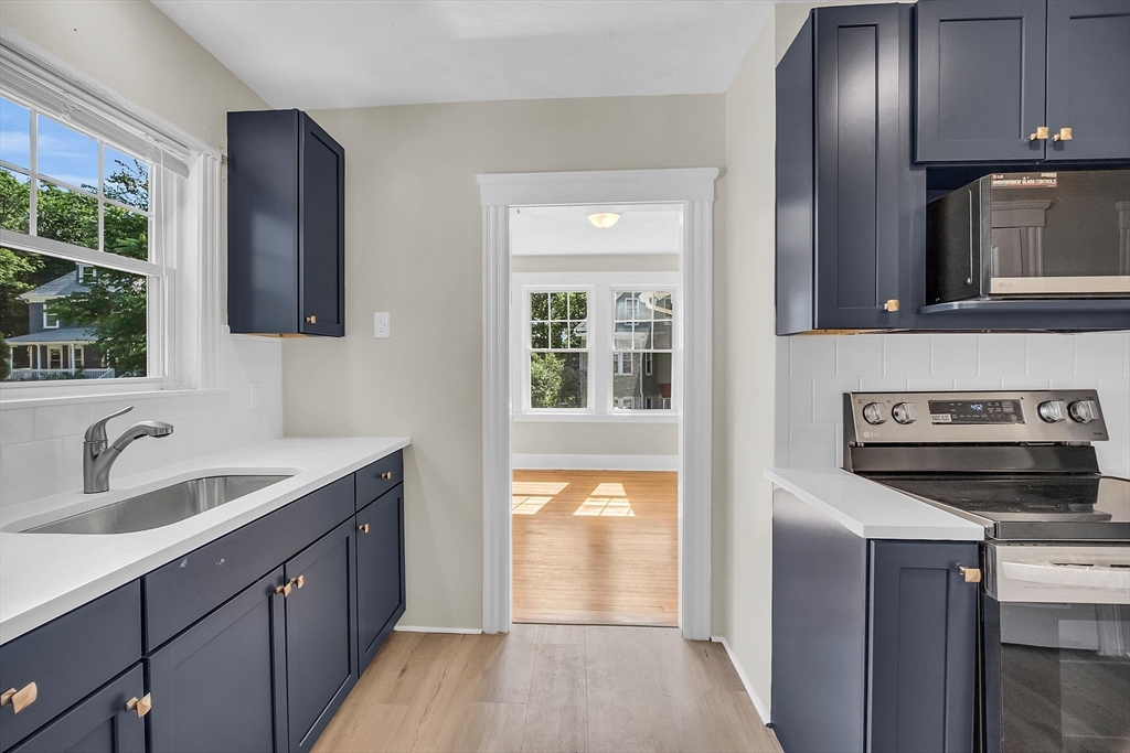 5 Wakefield Street Worcester, MA 01605 - Photo 23 of 42 a kitchen with a refrigerator stove and sink
