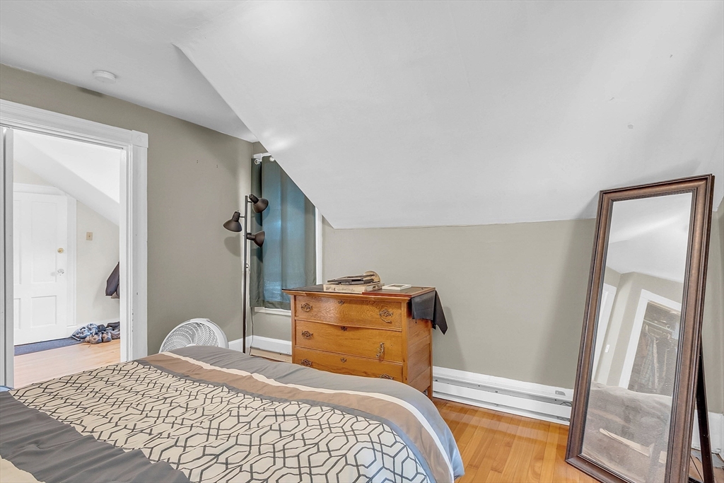 5 Wakefield Street Worcester, MA 01605 - Photo 34 of 42 a bedroom with a bed and wooden floor
